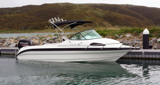 Reflex 585SC boat moored at dock side view