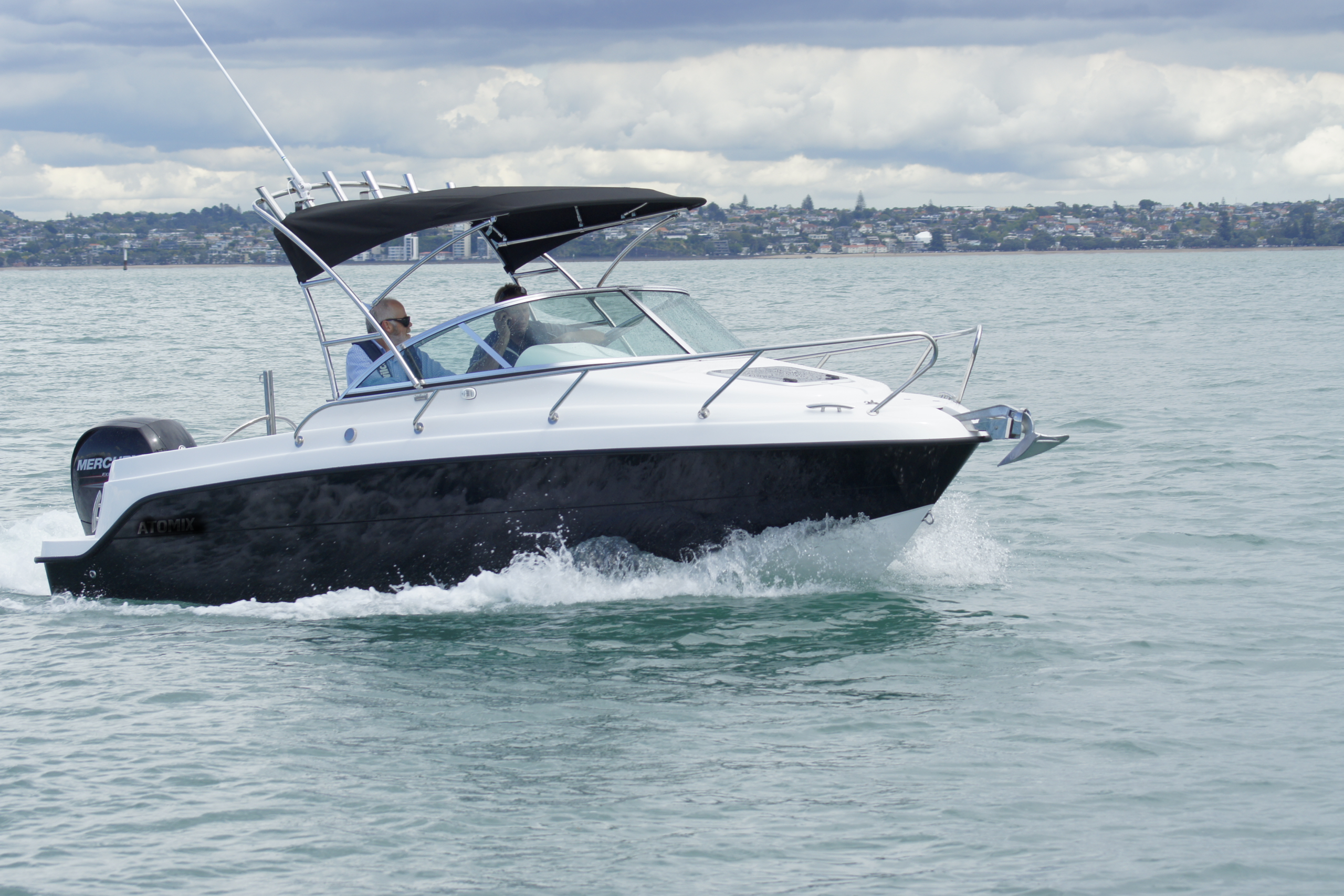 Reflex 560SC boat on calm water with foreshore in the background